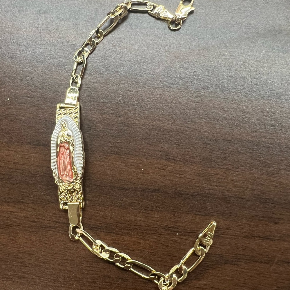 Religious fashion gold toned bracelet.